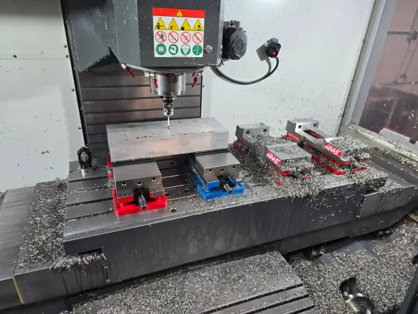 CNC milling operation with precision fixturing at Olympus Machining